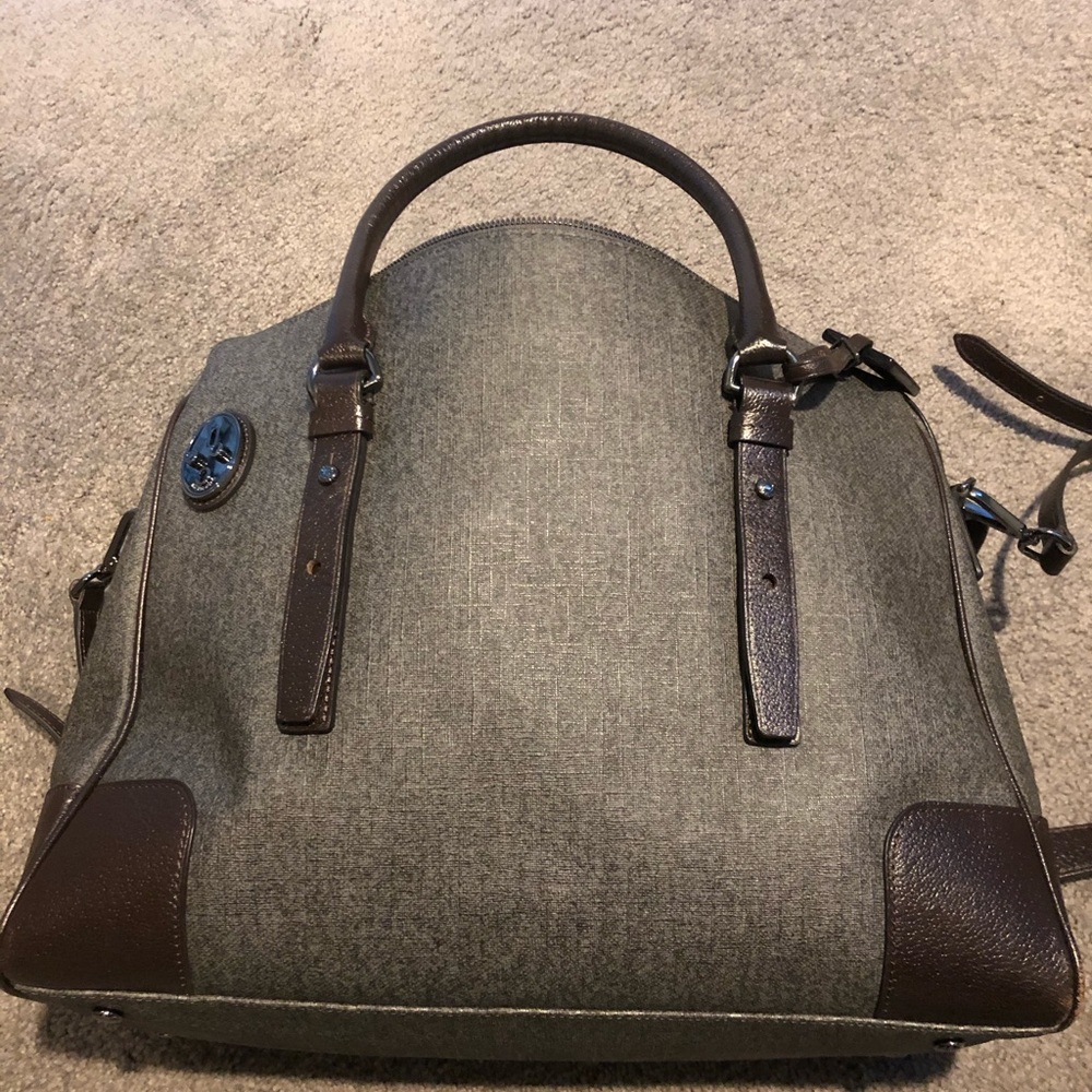 Tumi carry on bag with multiple pockets.